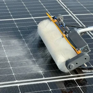 Solar panel cleaning equipment single horizontal rotating brush right view on solar panels with water spraying